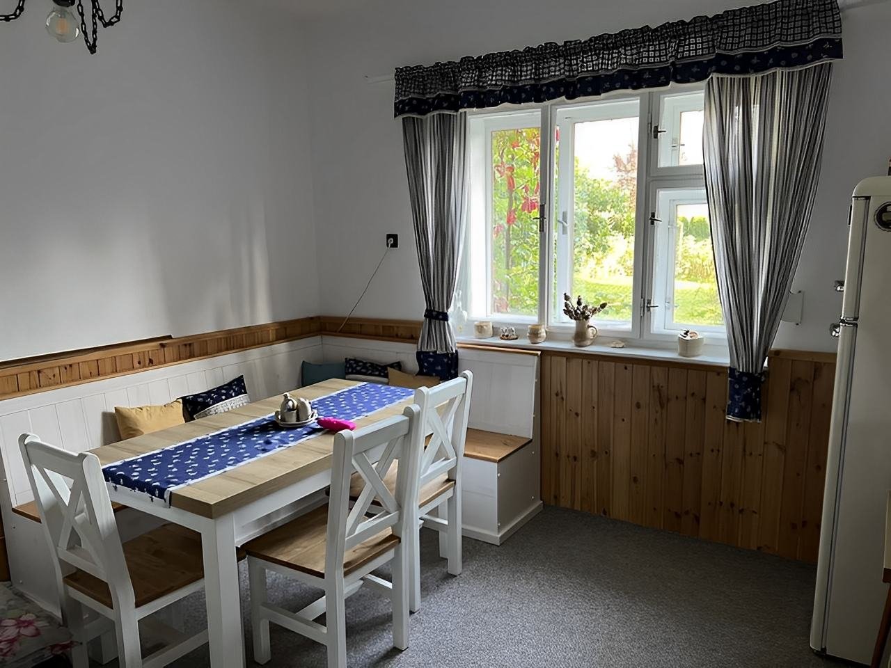 Stylové posezení u okna, ideální pro společné snídaně i večery s vínem.